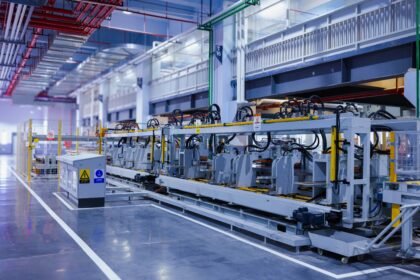 An automated forming line inside a manufacturing plant, where equipment lead times are actually set