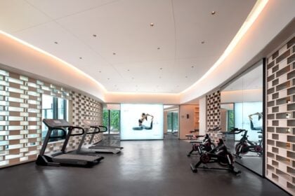 Treadmills and exercise bikes on a commercial fitness floor; illustrative equipment photograph.