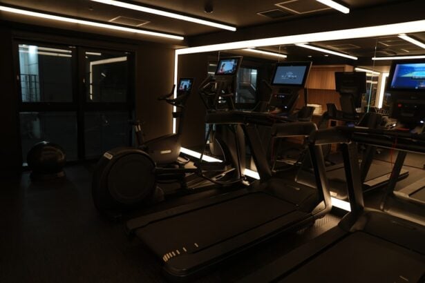 Console screens on a dark cardio floor where gym equipment firmware updates run overnight