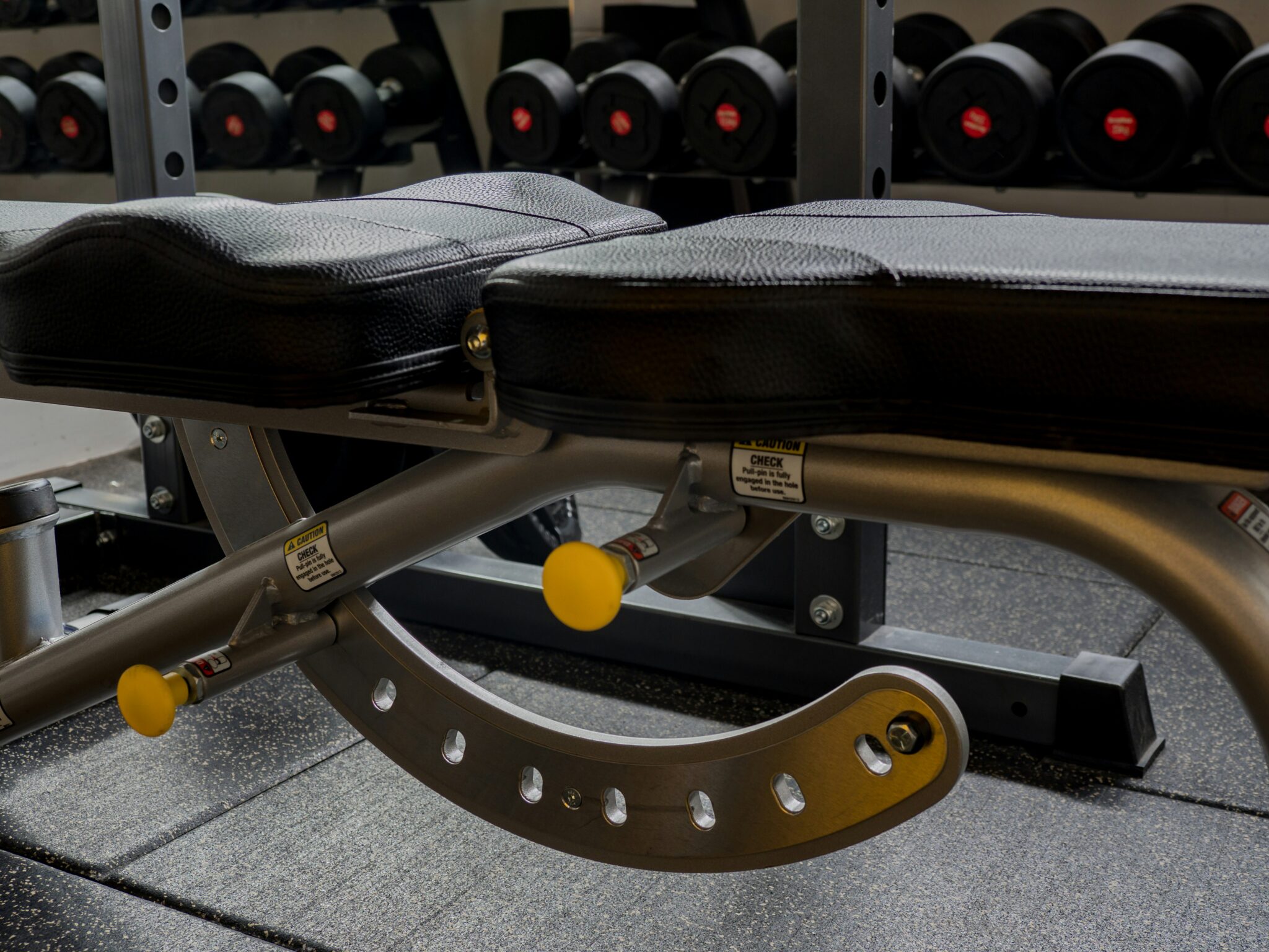Padded bench surface where gym equipment upholstery wear first becomes visible