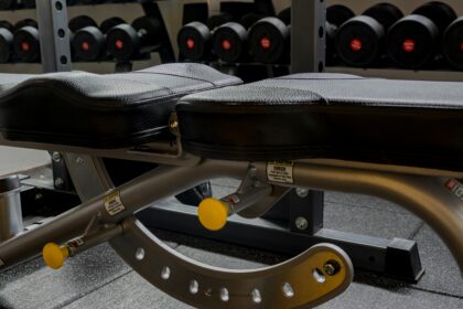 Padded bench surface where gym equipment upholstery wear first becomes visible