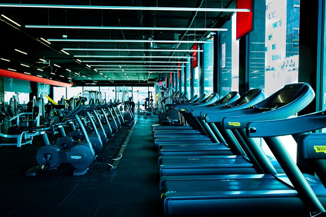 Rows of cardio machines on a club floor where gym equipment liability exposure is created and recorded