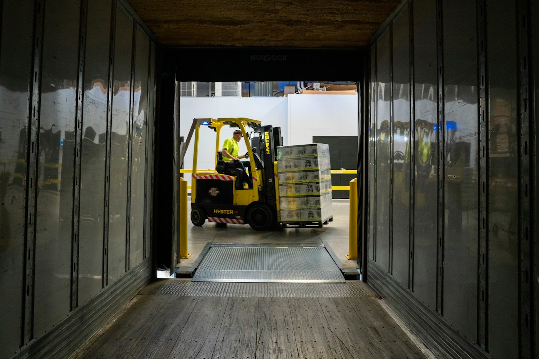 A forklift moving a pallet, the single highest-risk step in warehouse material handling for equipment distributors