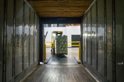 Forklift handling freight at a warehouse covered by distributor territory agreements