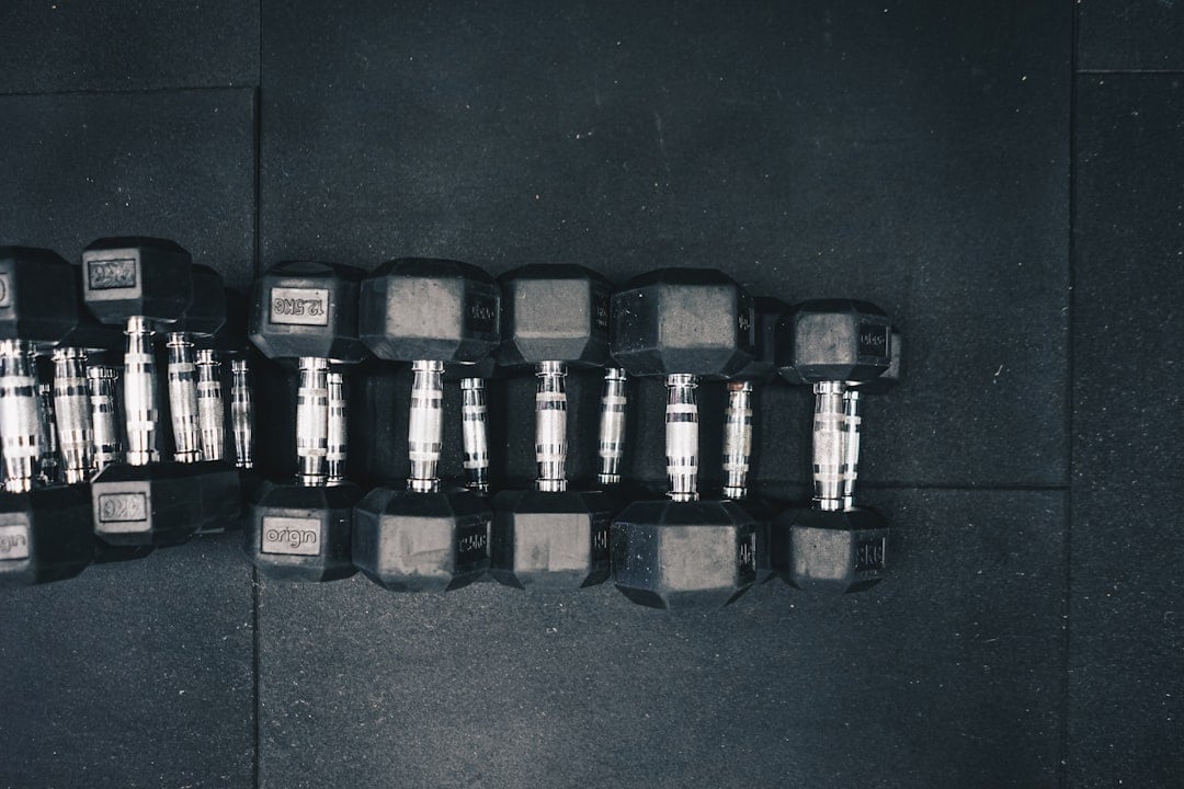 Hex dumbbells racked on a strength floor where gym noise control begins with equipment choice