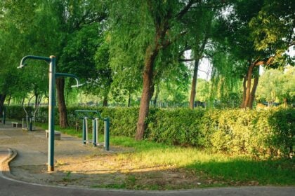 Anchored outdoor fitness equipment stations installed on a public green space