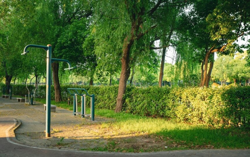 Anchored outdoor fitness equipment stations installed on a public green space