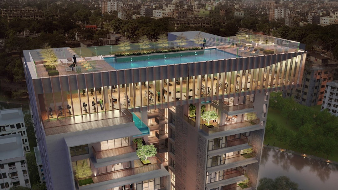 Rooftop amenity deck of the kind where outdoor fitness equipment is specified alongside an indoor gym