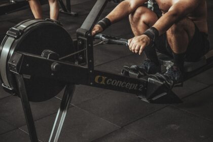 Commercial rowing machines under load on a busy training floor