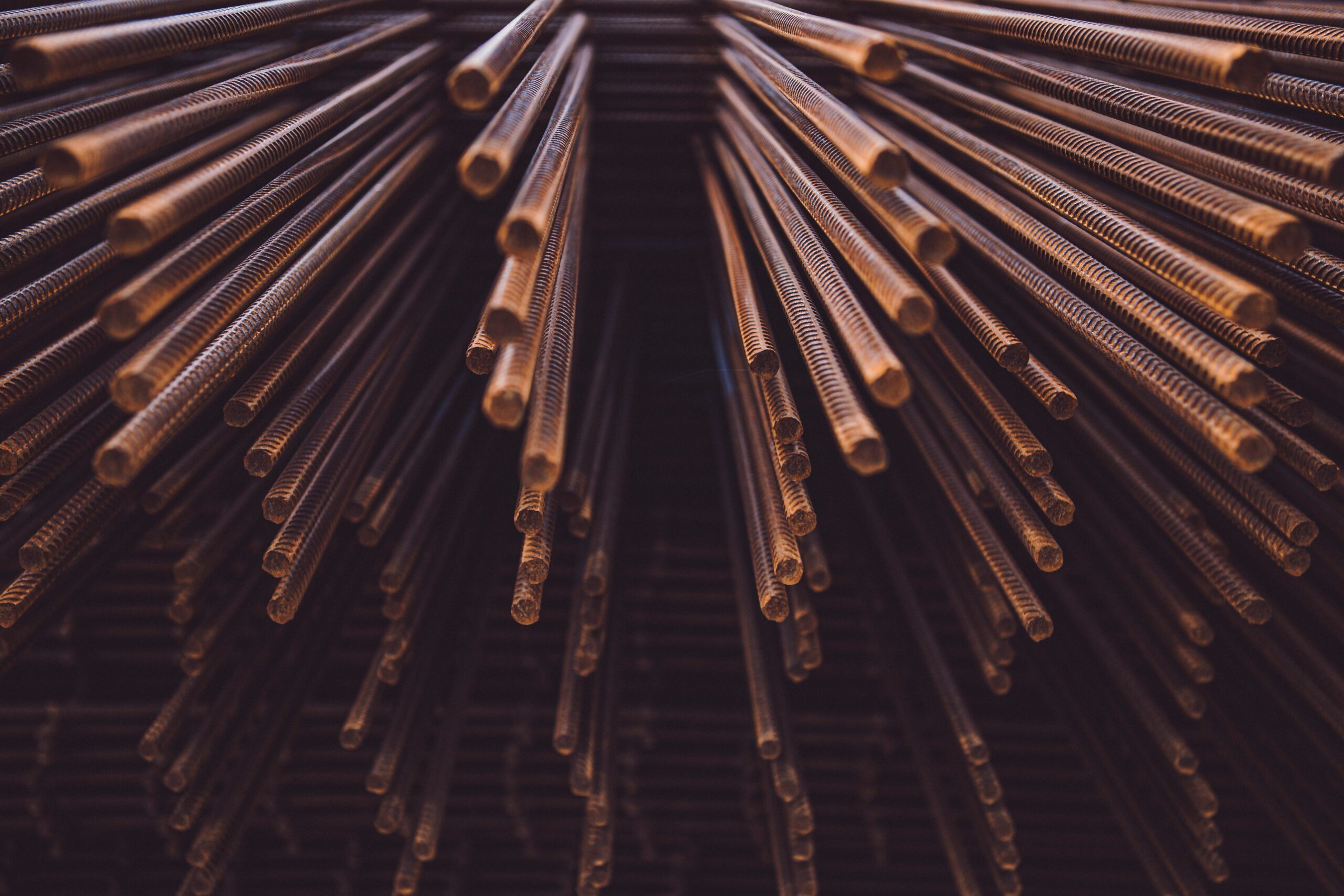 Steel bar stock waiting to be cut, the upstream input behind equipment lead times