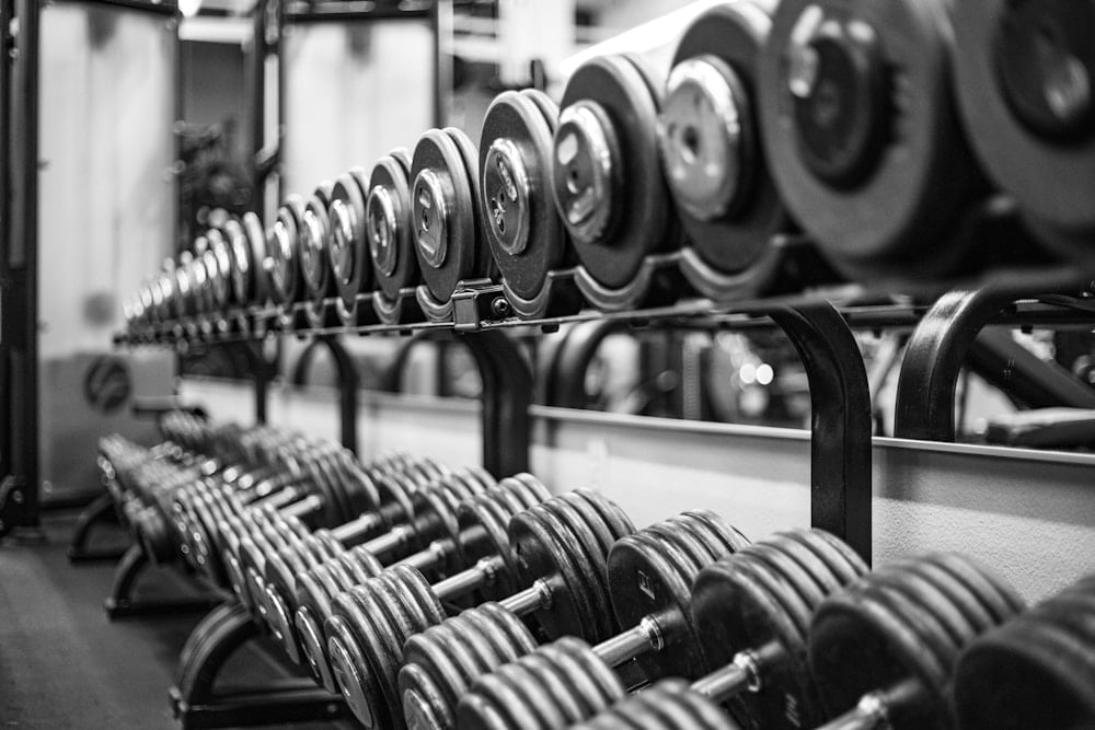 Rows of dumbbells and loaded stations showing how strength equipment trends read on a commercial floor